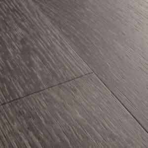 Close-up detail of Quick-Step Alpha Blos Silk Oak Dark Grey vinyl flooring showing textured surface and grain pattern