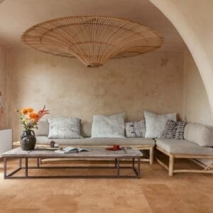 Quick-Step Muse Terracotta Laminate Flooring MUS5490 in a living room with arched ceiling and natural decor