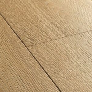 Quick-Step Capture Brushed Oak Warm Natural laminate flooring in a dining area with red chairs