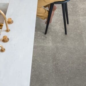 Modern dining area with Dusky Bluestone laminate flooring, white brick wall and wooden table
