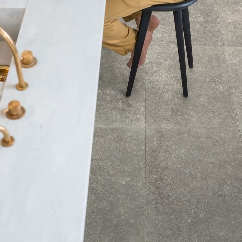 Modern dining area with Dusky Bluestone laminate flooring, white brick wall and wooden table