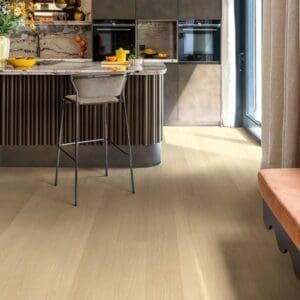 Contemporary kitchen with dark cabinetry and Quick-Step Capture Beige Varnished Oak flooring