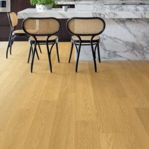Quick-Step Capture Natural Varnished Oak laminate flooring installed in a modern kitchen with marble countertops