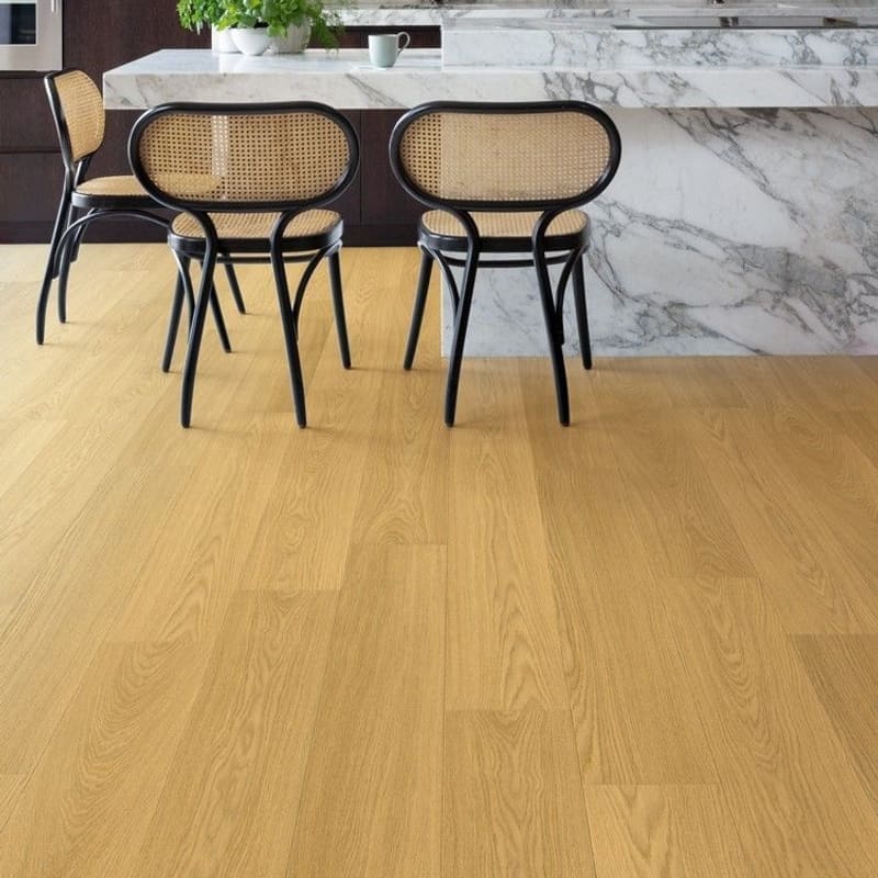 Quick-Step Capture Natural Varnished Oak laminate flooring installed in a modern kitchen with marble countertops