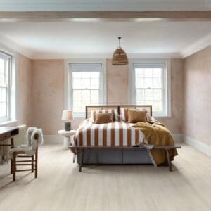 Bedroom with White Premium Oak flooring featuring peach walls and wooden furniture