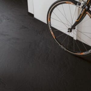 Hallway with bicycle showing Quick-Step Black Slate Laminate flooring
