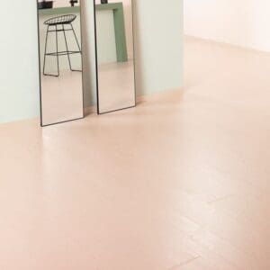 Minimalist interior with full-length mirrors on Painted Oak Rose flooring
