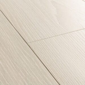 Detailed view of White Premium Oak laminate planks showing bevelled edges and grain pattern