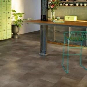 Quick-Step Alpha Oro Oxidized Rock vinyl flooring installed in a modern kitchen with wooden beams