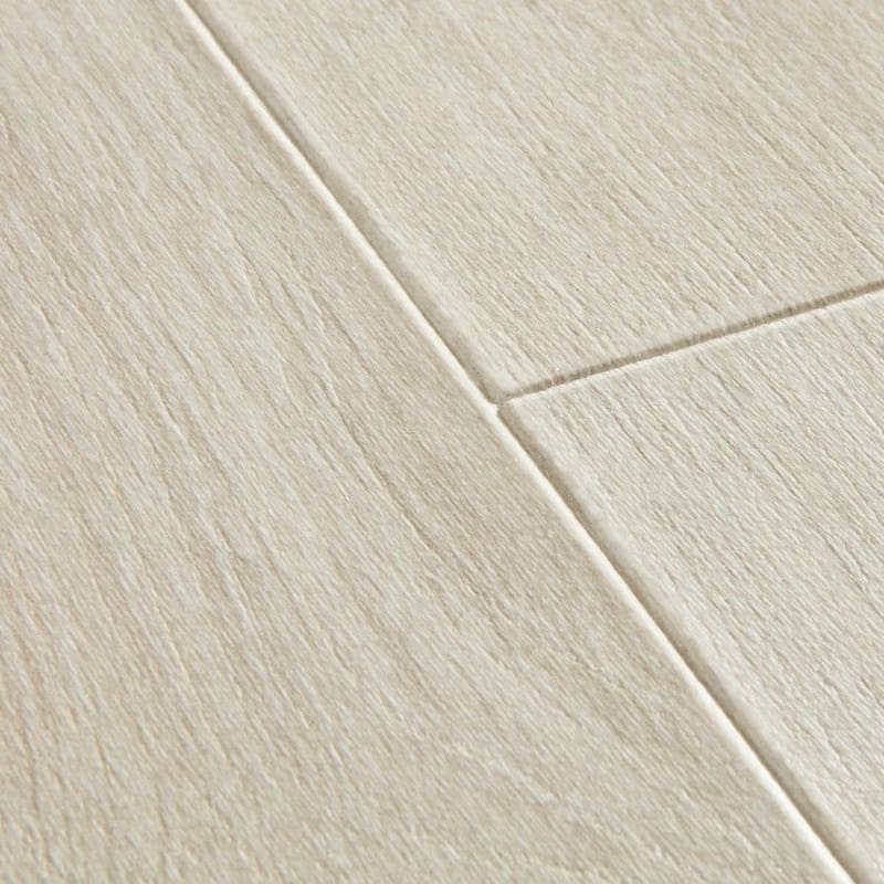 Close-up of Quick-Step Majestic Woodland Oak Light Grey laminate flooring showing beveled edge detail and texture