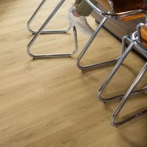Close-up of Quick-Step Capture Brushed Oak Warm Natural laminate flooring with water droplets