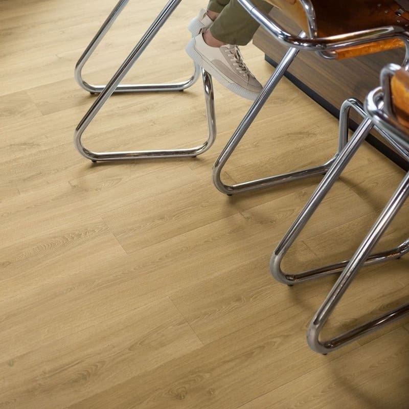 Close-up of Quick-Step Capture Brushed Oak Warm Natural laminate flooring with water droplets