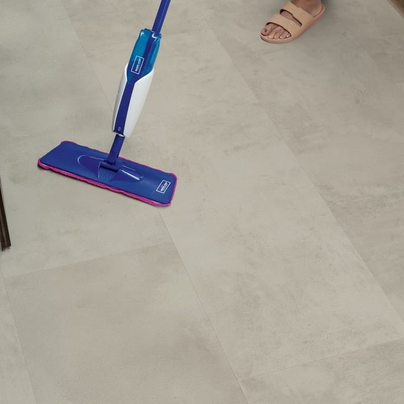 Close-up of water droplets on Quick-Step Grey Concrete Laminate flooring showing water resistance