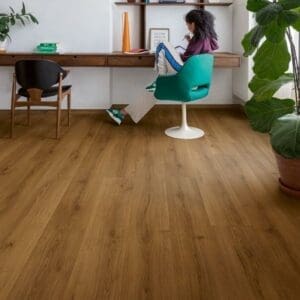 Home office with Quick-Step Botanic Caramel Oak flooring featuring wooden desk and green chair