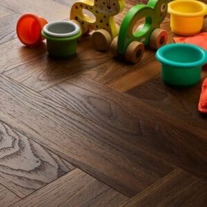 Textures warm walnut herringbone flooring with colorful children's toys showing domestic application